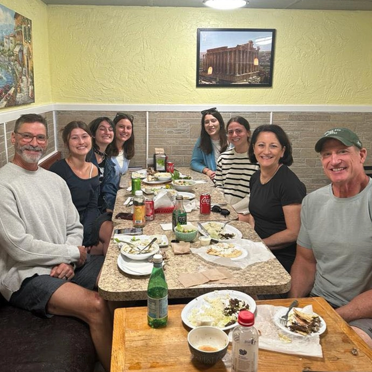 A family filling the corner booth at Lily's, plates across the table